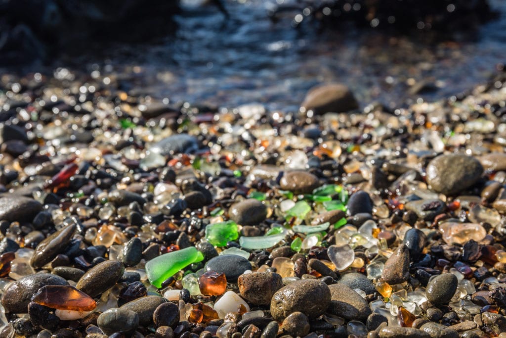 close-up of sea glass on a rocky beach