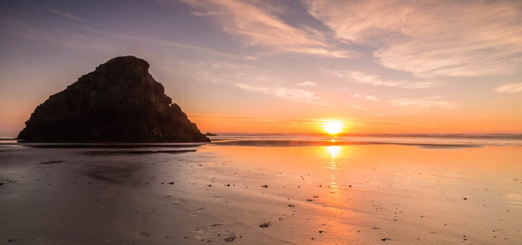 beach sunset with a rocky outcrop